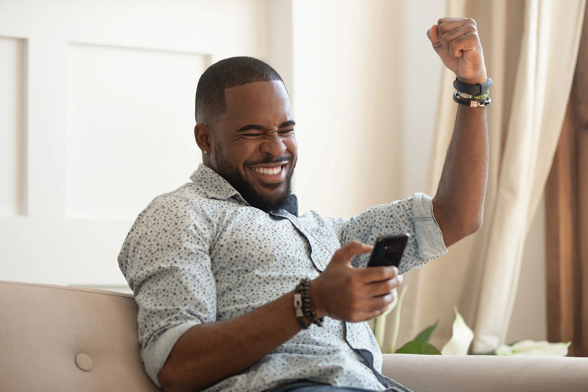 Customer celebrating consumer financing approval on mobile device